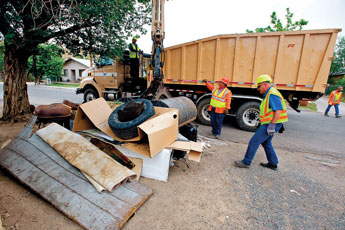 Gallup city workers pick up trash from a residence on the north side July 16, during the first of six bulk trash pickups. The effort is part of an ongoing city cleanup. Independent file photo